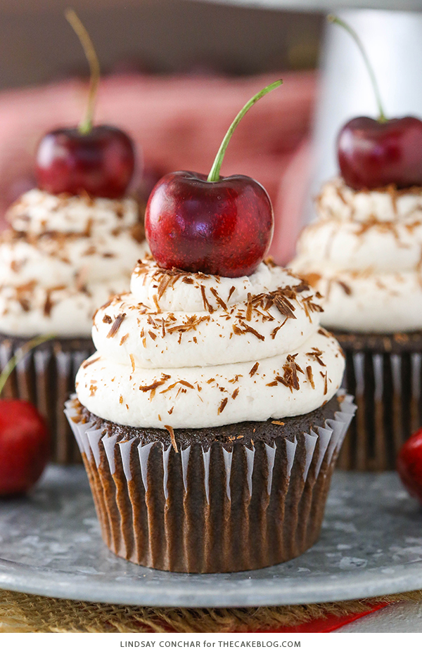 Black Forest Cupcakes - moist chocolate cupcake, homemade cherry filling and fresh vanilla whipped cream on top | by Lindsay Conchar for TheCakeBlog.com