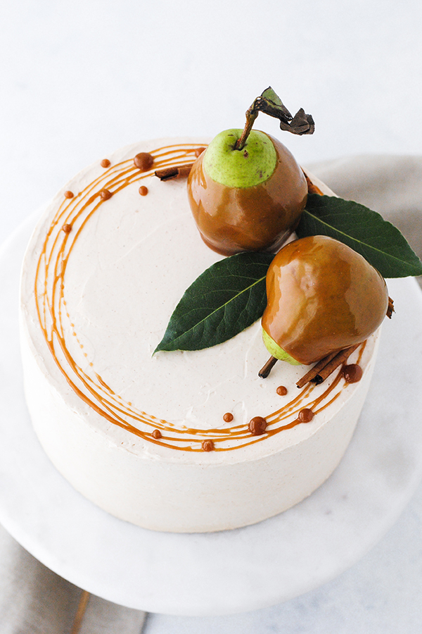 Salted Caramel Pear Cake - fresh pear cake with cinnamon buttercream, salted caramel and homemade caramel dipped pears | Carrie Sellman for TheCakeBlog.com
