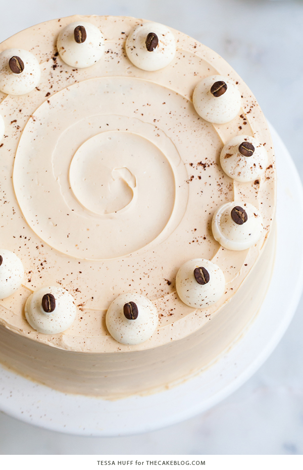 Caramel Cappuccino Cake - espresso cake paired with caramel buttercream frosting, topped with whole coffee beans and a sprinkle of cocoa powder | by Tessa Huff for TheCakeBlog.com