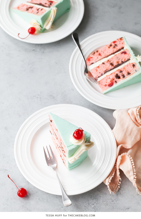 Cherry Chip Cake - maraschino cherry cake studded with chocolate chips, layered with chocolate ganache and finished with a whipped vanilla buttercream frosting | by Tessa Huff for TheCakeBlog.com