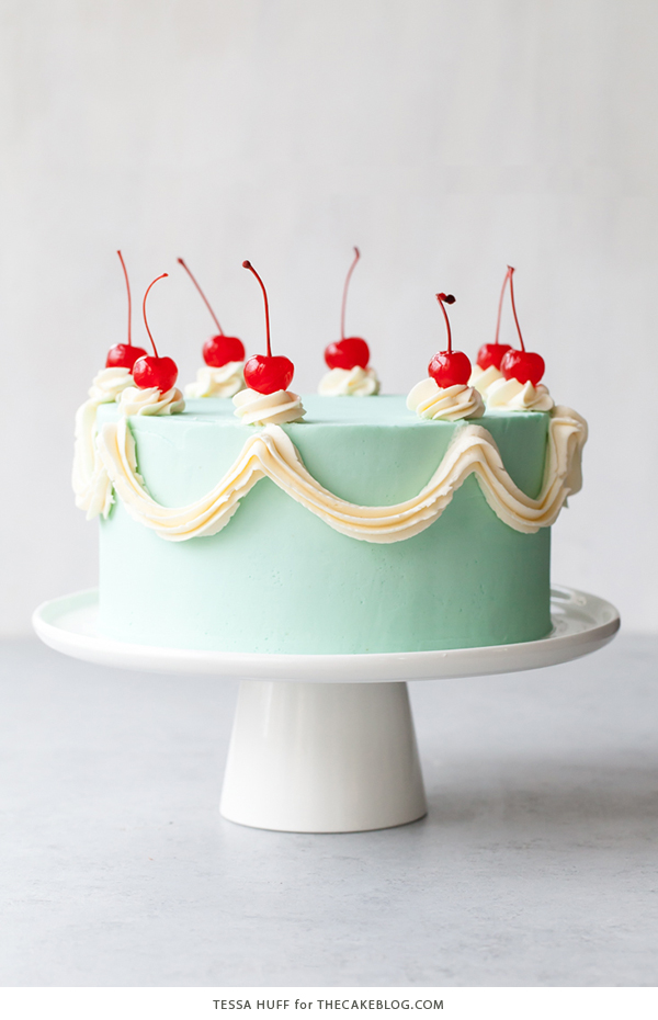 Cherry Chip Cake - maraschino cherry cake studded with chocolate chips, layered with chocolate ganache and finished with a whipped vanilla buttercream frosting | by Tessa Huff for TheCakeBlog.com