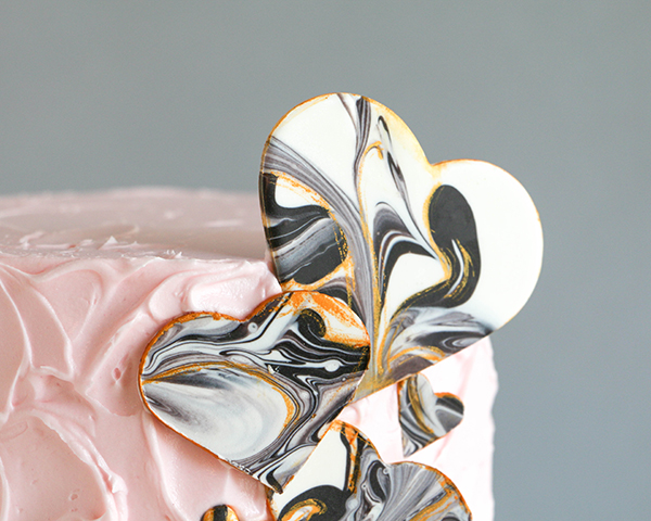 Marble Chocolate Hearts - how to make marbled heart toppers for cakes and cupcakes using chocolate coating and cookie cutters | by Erin Gardner for TheCakeBlog.com