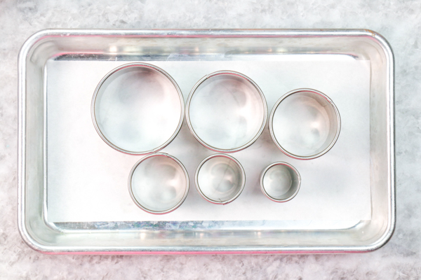 Sprinkle Ornament Cake – how to make sparkling ornaments for cakes and cupcakes using chocolate, cookie cutters and sprinkles | by Erin Gardner for TheCakeBlog.com