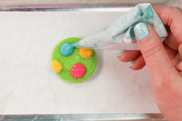 Sprinkle Ornament Cake – how to make sparkling ornaments for cakes and cupcakes using chocolate, cookie cutters and sprinkles | by Erin Gardner for TheCakeBlog.com