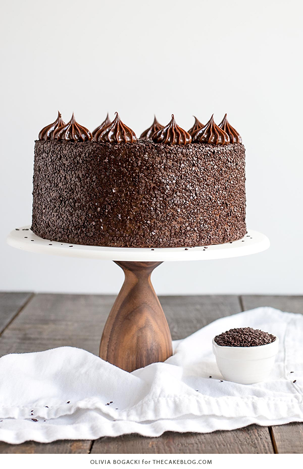 Chocolate Truffle Cake - a chocolate layer cake recipe with dense, moist chocolate cake, silky chocolate truffle frosting and chocolate flakes | by Olivia Bogacki for TheCakeBlog.com