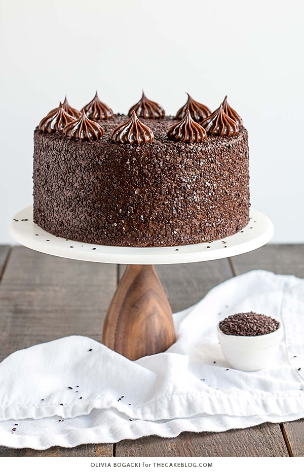 Chocolate Truffle Cake - a chocolate layer cake recipe with dense, moist chocolate cake, silky chocolate truffle frosting and chocolate flakes | by Olivia Bogacki for TheCakeBlog.com