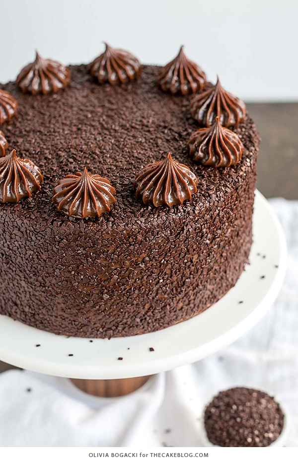 Chocolate Truffle Cake - a chocolate layer cake recipe with dense, moist chocolate cake, silky chocolate truffle frosting and chocolate flakes | by Olivia Bogacki for TheCakeBlog.com
