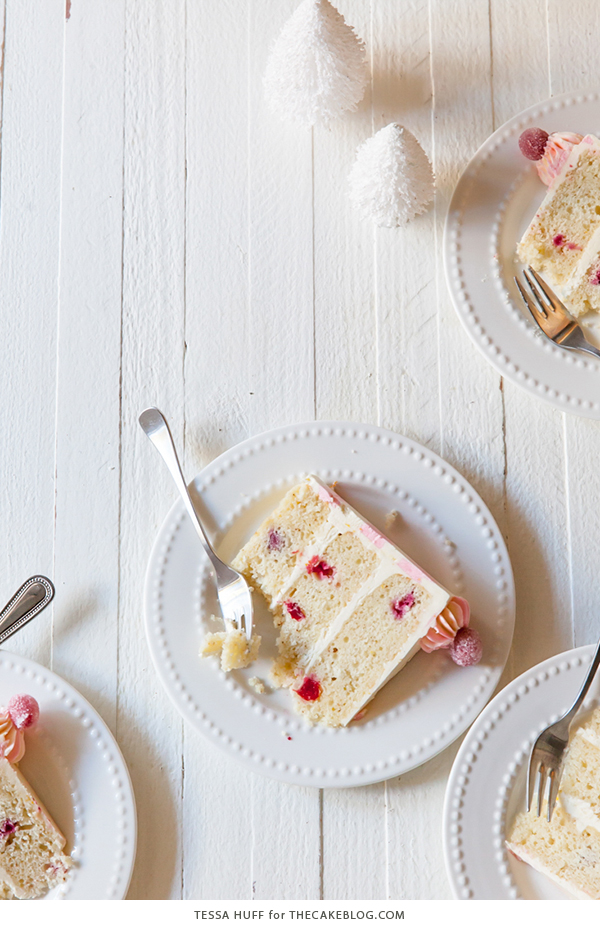 Cranberry Orange Spice Cake - orange cake studded with cranberries topped with white chocolate orange frosting in festive pink and white buttercream stripes | by Tessa Huff for TheCakeBlog.com