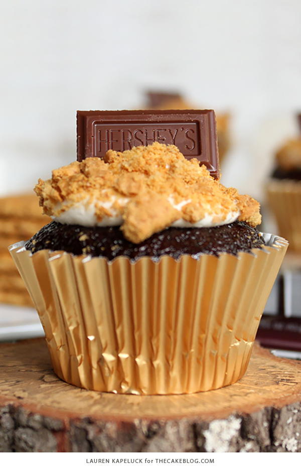 S'mores Cupcakes - easy s'more inspired cupcake recipe with chocolate cupcakes, marshmallow frosting, graham cracker crumbs and a hunk of milk chocolate | by Lauren Kapeluck for TheCakeBlog.com