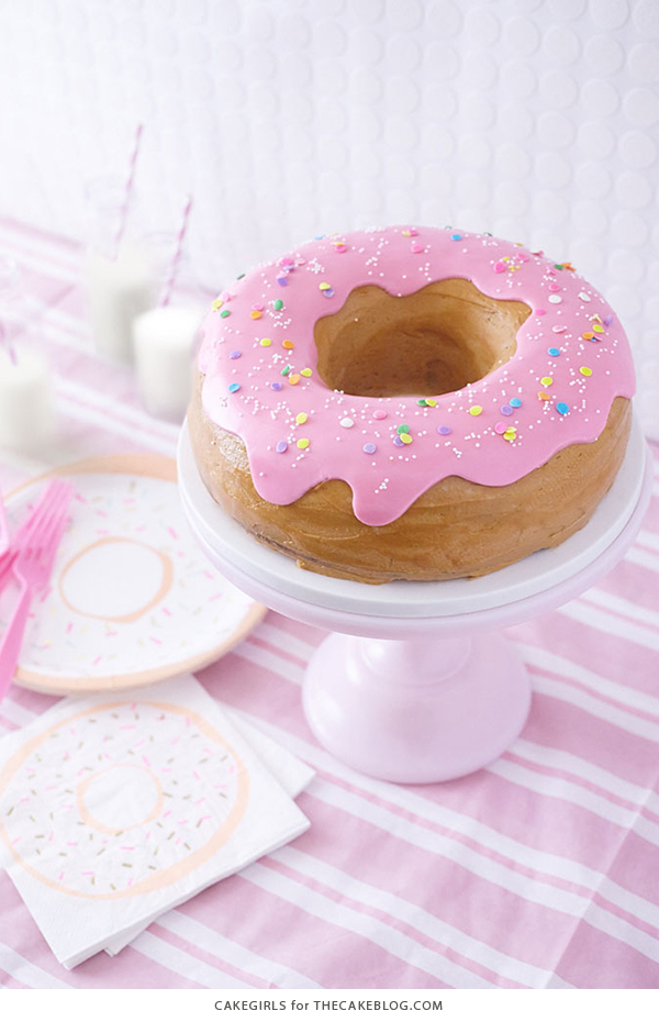 Giant Donut Cake! Learn how to make this adorable, sprinkle-coated, giant donut cake with a simple step-by-step tutorial | by Cakegirls for TheCakeBlog.com