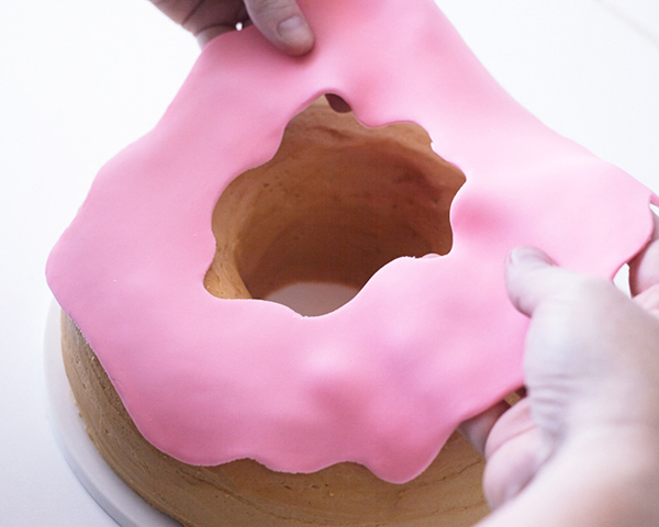 Giant Donut Cake! Learn how to make this adorable, sprinkle-coated, giant donut cake with a simple step-by-step tutorial | by Cakegirls for TheCakeBlog.com