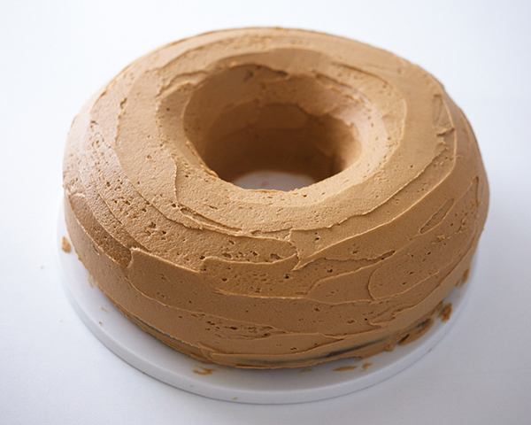 Giant Donut Cake! Learn how to make this adorable, sprinkle-coated, giant donut cake with a simple step-by-step tutorial | by Cakegirls for TheCakeBlog.com