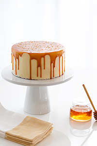 Honey Butter Cake | honey cake with honey cream cheese frosting topped with a honey butterscotch glaze | by Carrie Sellman for TheCakeBlog.com