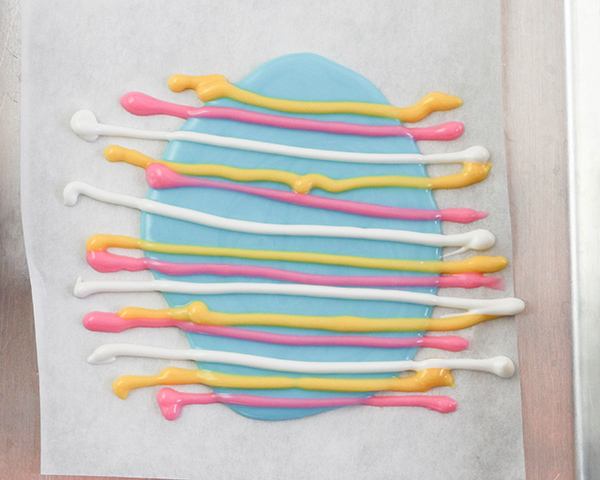 Marbled Chocolate Easter Eggs - how to make marbled Easter egg toppers for cakes and cupcakes using chocolate coating and cookie cutters | by Erin Gardner for TheCakeBlog.com