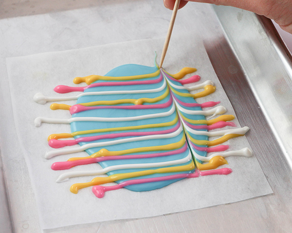 Marbled Chocolate Easter Eggs - how to make marbled Easter egg toppers for cakes and cupcakes using chocolate coating and cookie cutters | by Erin Gardner for TheCakeBlog.com