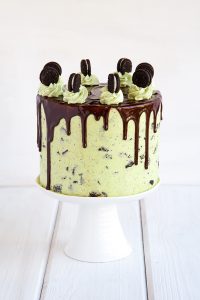 Mint Cookies 'N Cream Cake with crushed cookies in the cake and frosting plus a chocolate drip | by Tessa Huff for TheCakeBlog.com
