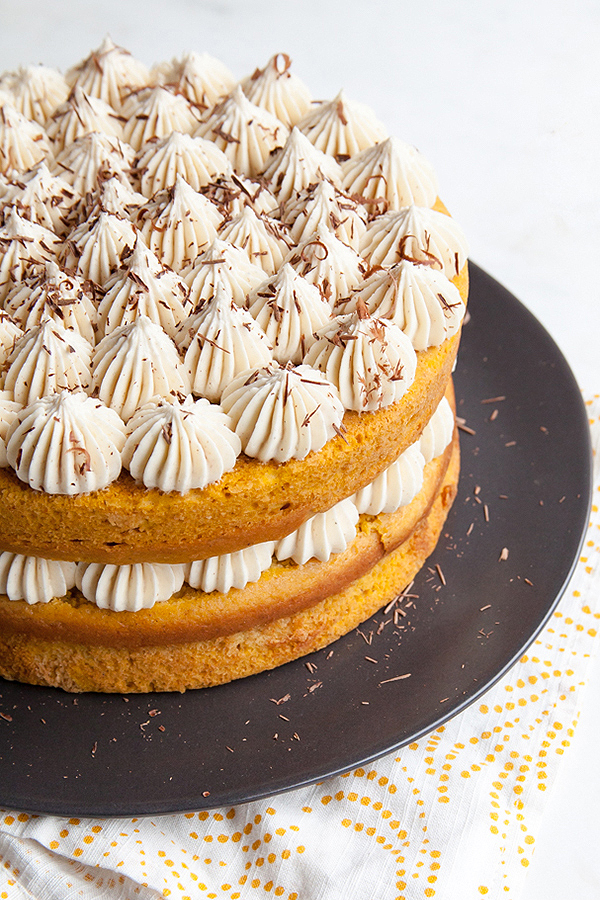 Pumpkin Tiramisu Cake. Pumpkin cake soaked with coffee liqueur, layered with mascarpone frosting and chocolate shavings | Tessa Huff for TheCakeBlog.com