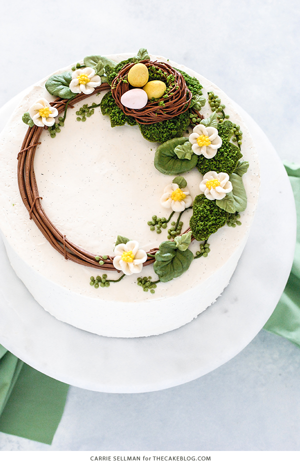 Spring Wreath Cake - how to make a buttercream wreath cake a bird's nest, cherry blossoms, green berries and cookie moss | by Carrie Sellman for TheCakeBlog.com #easter #easterdinnerideas #mothersday #cake