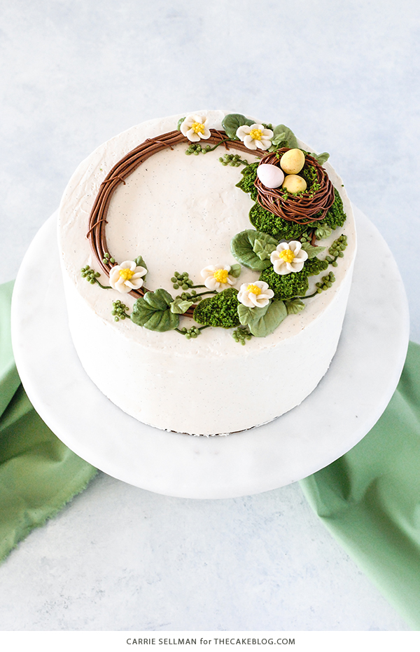 Spring Wreath Cake - how to make a buttercream wreath cake a bird's nest, cherry blossoms, green berries and cookie moss | by Carrie Sellman for TheCakeBlog.com #easter #easterdinnerideas #mothersday #cake