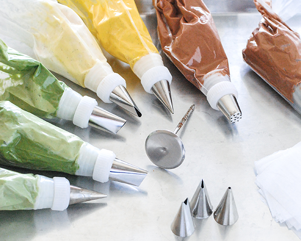 Spring Wreath Cake - how to make a buttercream wreath cake a bird's nest, cherry blossoms, green berries and cookie moss | by Carrie Sellman for TheCakeBlog.com #easter #easterdinnerideas #mothersday #cake