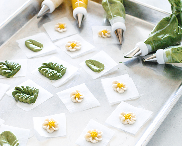 Spring Wreath Cake - how to make a buttercream wreath cake a bird's nest, cherry blossoms, green berries and cookie moss | by Carrie Sellman for TheCakeBlog.com #easter #easterdinnerideas #mothersday #cake