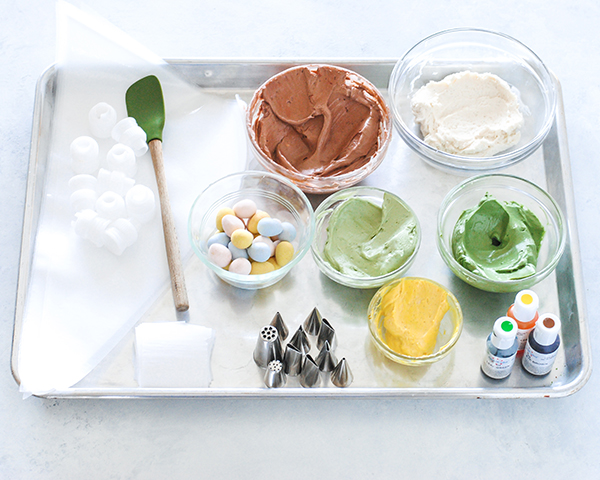 Spring Wreath Cake - how to make a buttercream wreath cake a bird's nest, cherry blossoms, green berries and cookie moss | by Carrie Sellman for TheCakeBlog.com #easter #easterdinnerideas #mothersday #cake