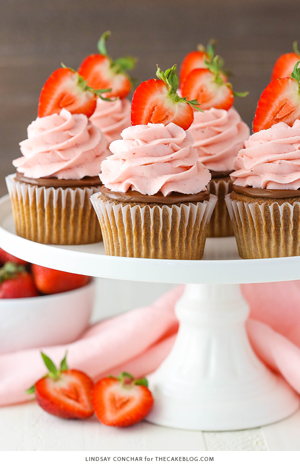 Strawberry Nutella Cupcakes with a soft, fluffy Nutella cupcake topped with more Nutella and a fresh strawberry frosting | by Lindsay Conchar for TheCakeBlog.com
