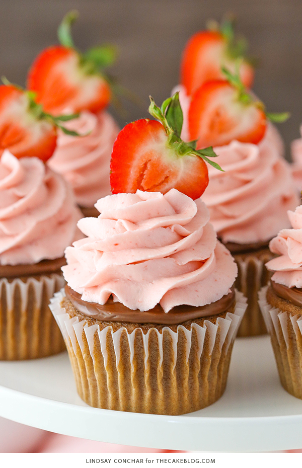 Strawberry Nutella Cupcakes with a soft, fluffy Nutella cupcake topped with more Nutella and a fresh strawberry frosting | by Lindsay Conchar for TheCakeBlog.com