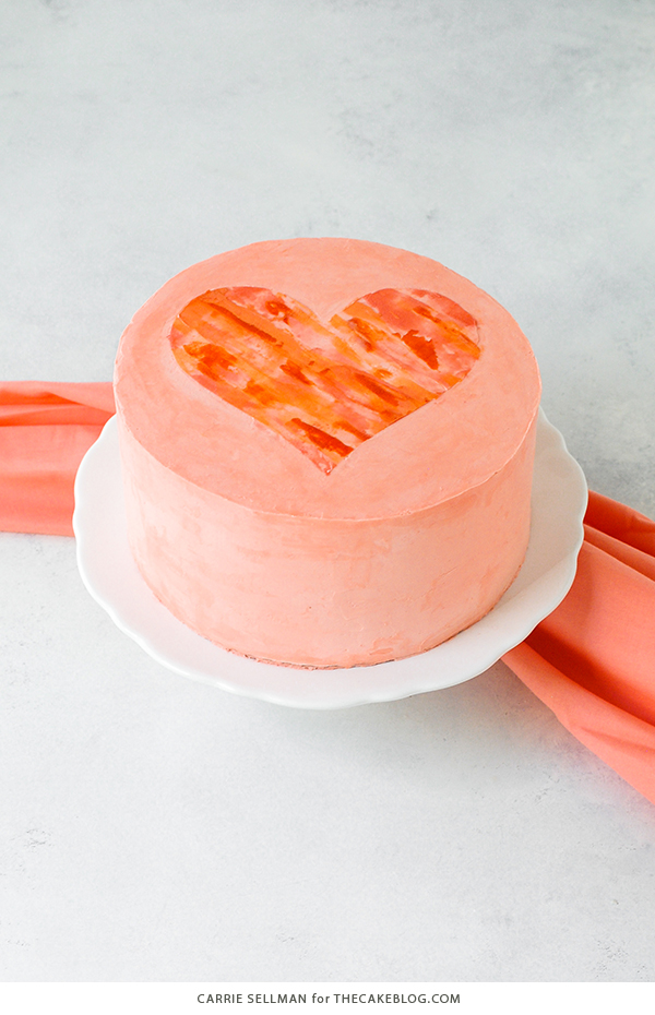 Watercolor Heart Cake - how to paint a watercolor heart cake using buttercream frosting and a parchment paper stencil | by Carrie Sellman for TheCakeBlog.com