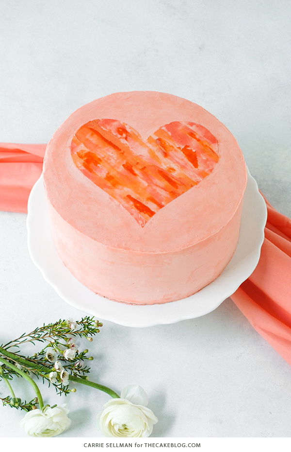 Watercolor Heart Cake - how to paint a watercolor heart cake using buttercream frosting and a parchment paper stencil | by Carrie Sellman for TheCakeBlog.com