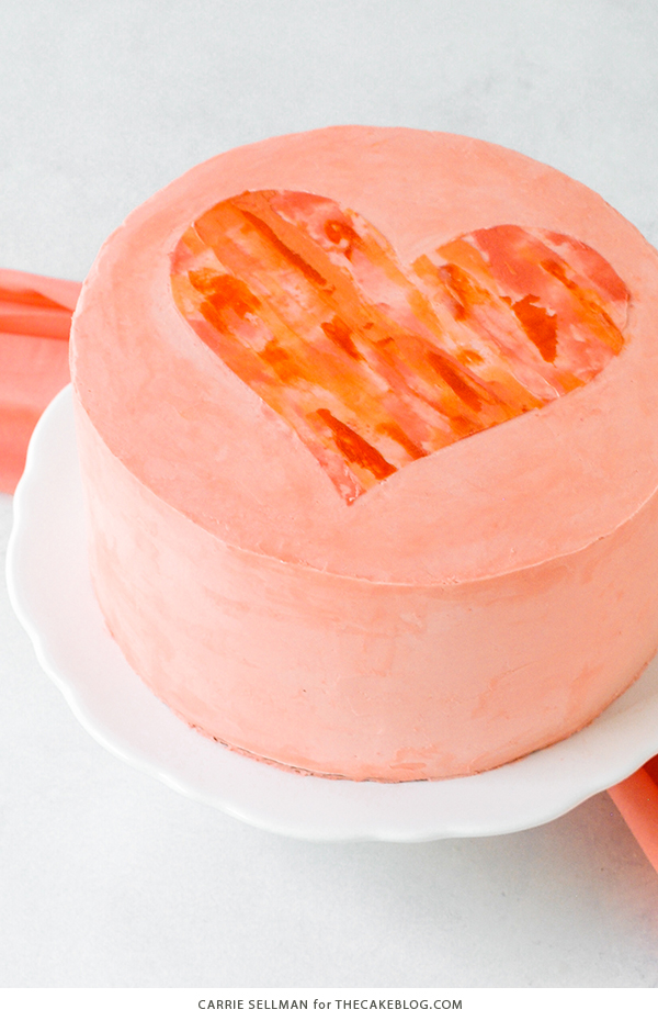 Watercolor Heart Cake - how to paint a watercolor heart cake using buttercream frosting and a parchment paper stencil | by Carrie Sellman for TheCakeBlog.com