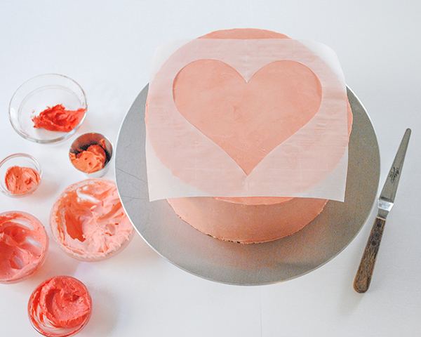 Watercolor Heart Cake - how to paint a watercolor heart cake using buttercream frosting and a parchment paper stencil | by Carrie Sellman for TheCakeBlog.com