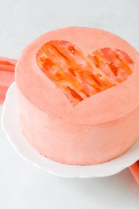 Watercolor Heart Cake - how to paint a watercolor heart cake using buttercream frosting and a parchment paper stencil | by Carrie Sellman for TheCakeBlog.com