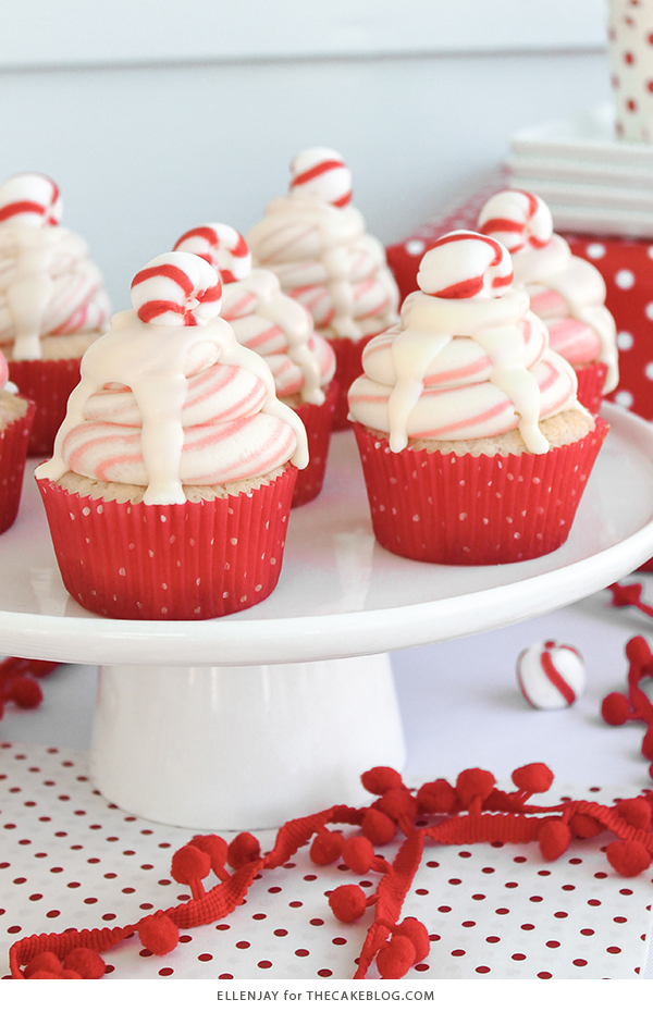 White Chocolate Peppermint Cupcakes - delicious white cake speckled with candy canes, topped with red and white swirled buttercream and white chocolate ganache | by ellenJAY for TheCakeBlog.com