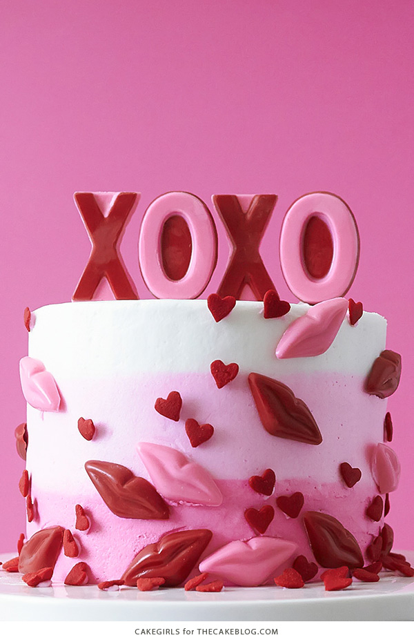 XOXO Valentine's Day Cake - how to make a pink ombre striped cake decorated with chocolate lips, hearts and an XOXO topper | by Cakegirls for TheCakeBlog.com