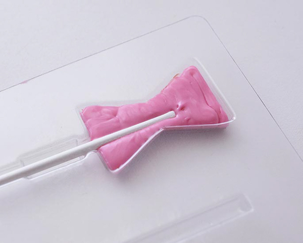 XOXO Valentine's Day Cake - how to make a pink ombre striped cake decorated with chocolate lips, hearts and an XOXO topper | by Cakegirls for TheCakeBlog.com