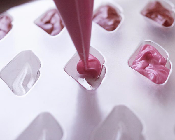 XOXO Valentine's Day Cake - how to make a pink ombre striped cake decorated with chocolate lips, hearts and an XOXO topper | by Cakegirls for TheCakeBlog.com